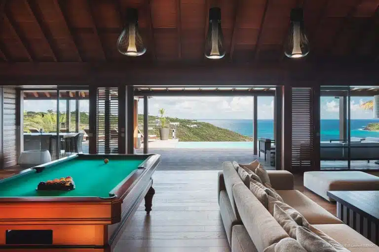 living room and pool table with ocean view in the mythique villa in st Barth