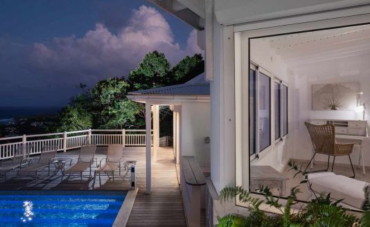 outdoor lounge area with pool, dinner table, long chairs with sea view - Milonga villa - luxury villa for rent in St Barts